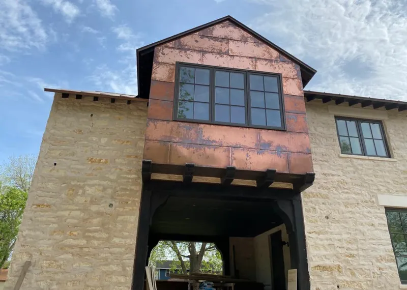 Copper metal panel facade on a stone building for Roof Repair in Minneola
